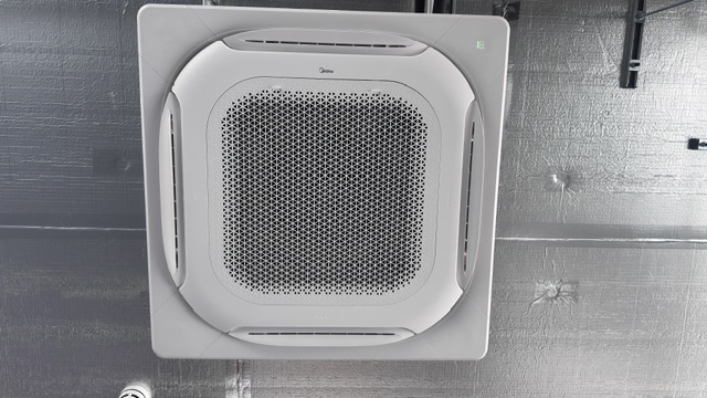 Close-up of a four-way ceiling cassette air conditioning unit