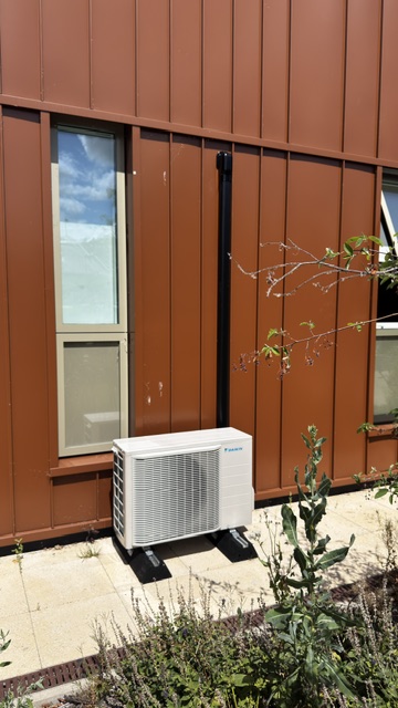 Outdoor air conditioning unit installed beside a school building